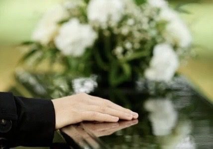 family members bearing a coffin